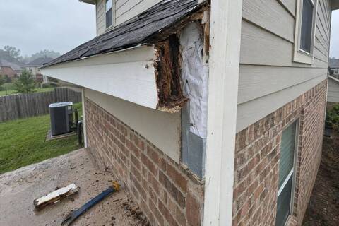 Corner trim and fascia at a roof edge with a section of rotted trim cut out
