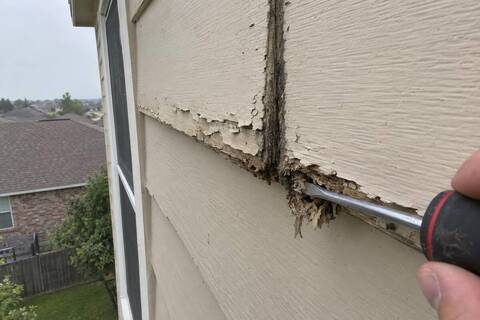 Swollen delaminating hardboard lap siding at a butt joint