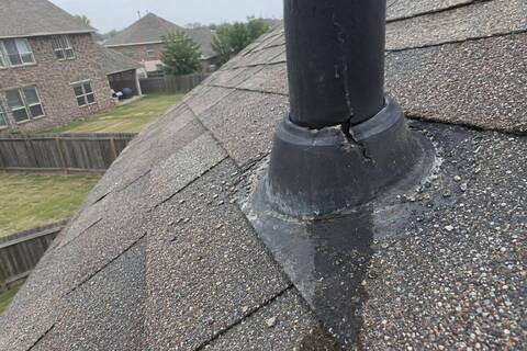 Cracked rubber collar around a plumbing vent pipe with a dark stain below